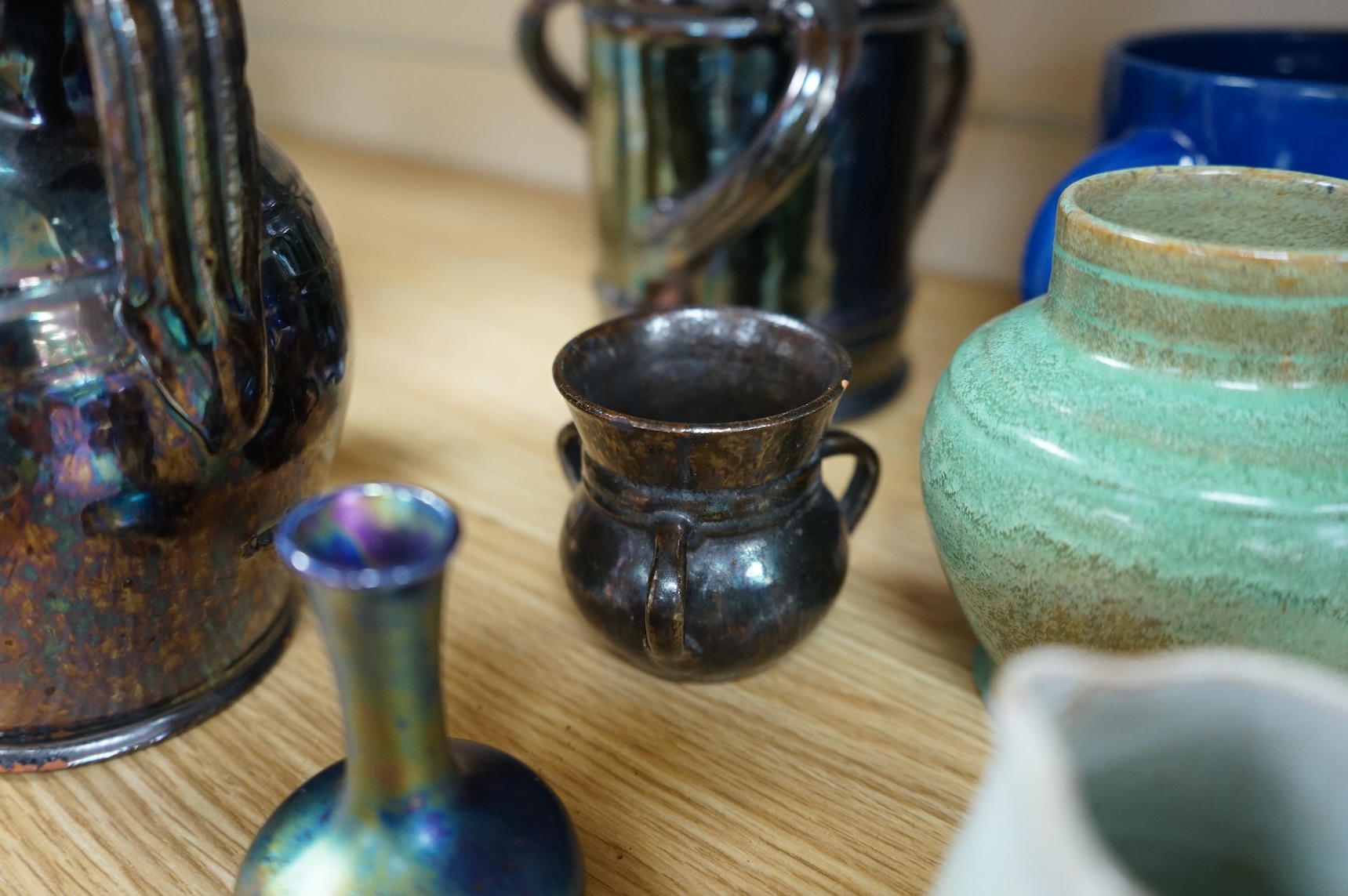A collection of pottery to include lustre glazed jugs and tygs, a T. G. Green storage jar, Carltonware ash tray and a miniature Ruskin style vase, largest 18cm high